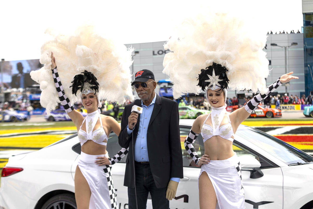 Actor Morgan Freeman, center, serves as the Grand Marshal for the pre-race ceremonies at the Pe ...