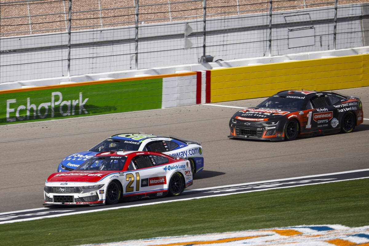 Driver Josh Berry (21) gets ahead of Daniel Suarez (99) to take the lead in the final laps of t ...