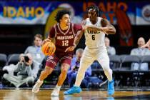 Montana guard Brandon Whitney (12) works the ball around the defense of Northern Colorado guard ...