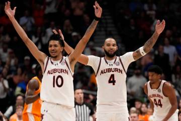 Auburn's Chad Baker-Mazara (10) and Johni Broome (4) react to play against Tennessee during the ...