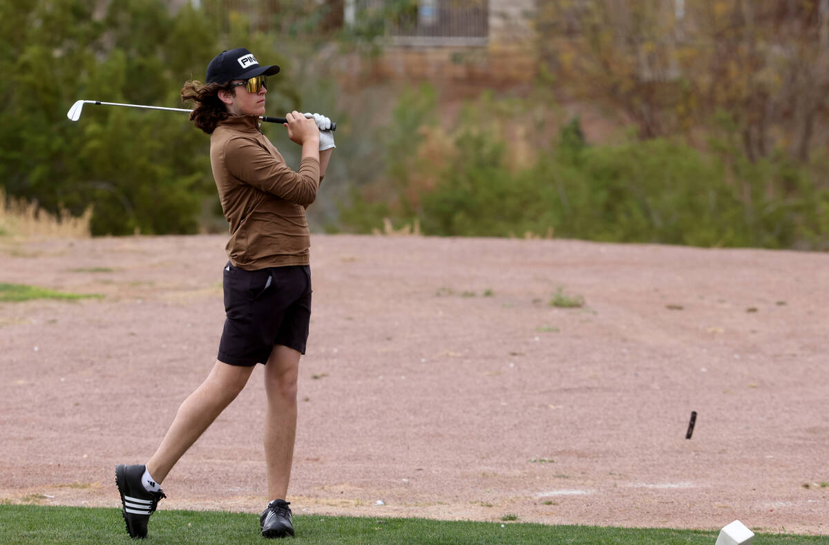Sky Pointe's Drake Harvey watches his tee shot on the second hole during the NIAA Class 4A boys ...