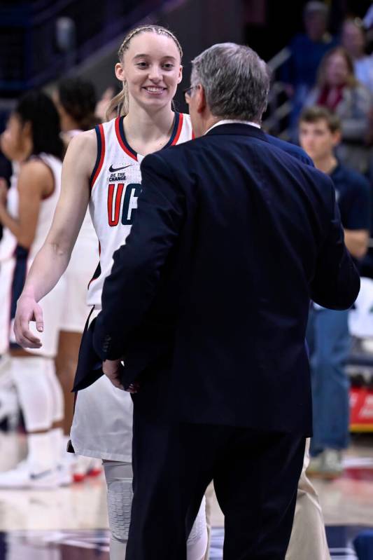 UConn guard Paige Bueckers and UConn head coach Geno Auriemma during senior day ceremonies afte ...