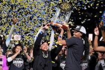South Carolina head coach Dawn Staley holds the trophy with forward Sania Feagin after their wi ...