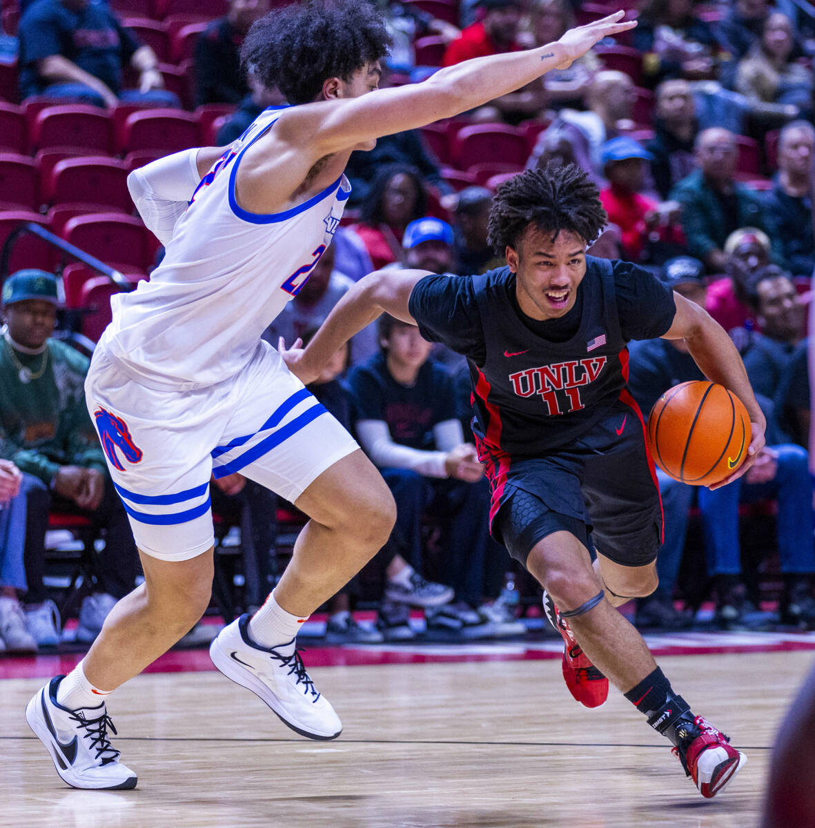 UNLV guard Dedan Thomas Jr. (11) drives the lane past Boise State Broncos forward Javan Buchana ...