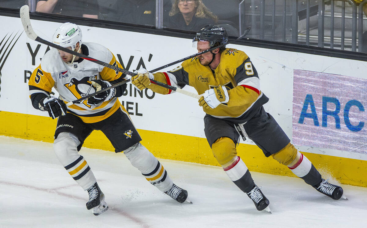 Golden Knights center Jack Eichel (9) takes a stick to the face from Pittsburgh Penguins defens ...
