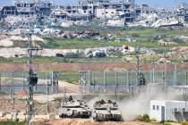 Israeli tanks maneuver on the border with northern Gaza Strip as seen from southern Israel, Tue ...