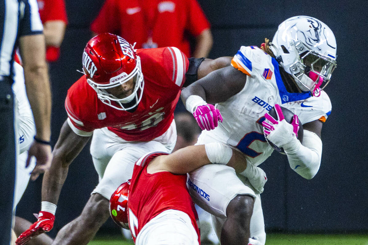 Boise State Broncos running back Ashton Jeanty (2) is turned back by UNLV linebacker Jackson Wo ...