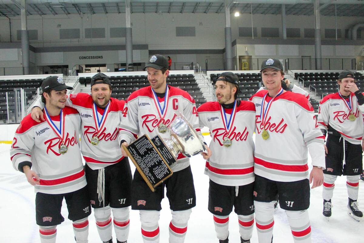 UNLV players pose with the trophy after beating Adrian College in the American Collegiate Hocke ...