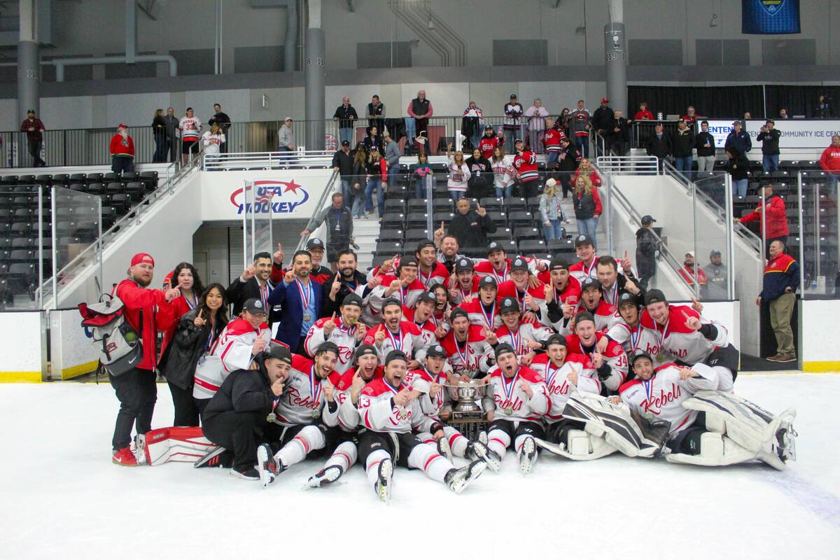 UNLV players pose with the trophy after beating Adrian College in the American Collegiate Hocke ...