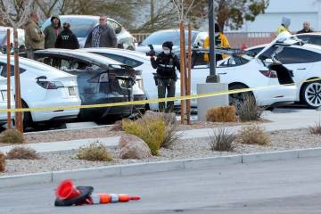 Metropolitan Police Department officers and crime scene analysts work the scene at Tesla Collis ...