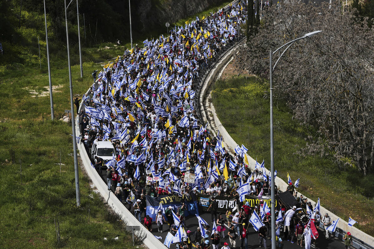 Israelis march on a highway toward Jerusalem to protest Prime Minister Benjamin Netanyahu's pla ...