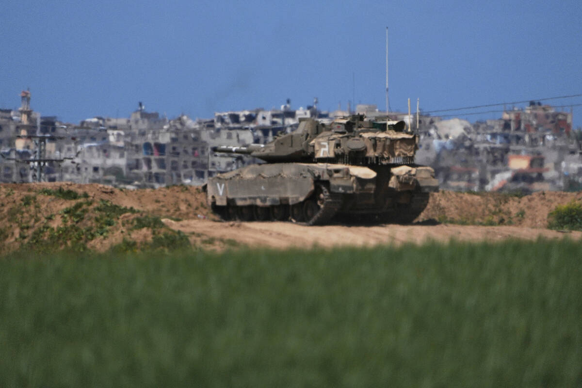 An Israeli tank takes position on the Gaza Strip border in southern Israel, Wednesday, March 19 ...