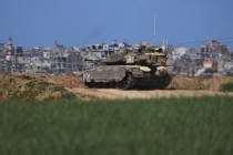 An Israeli tank takes position on the Gaza Strip border in southern Israel, Wednesday, March 19 ...