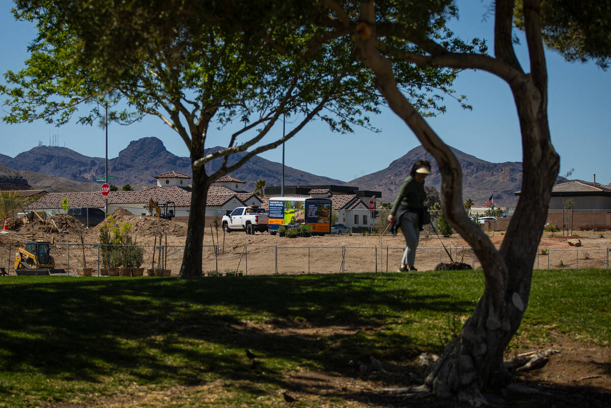 Janet Miller of Henderson walks her dog Mojo at Mission Hills Park on Wednesday, March 19, 2025 ...
