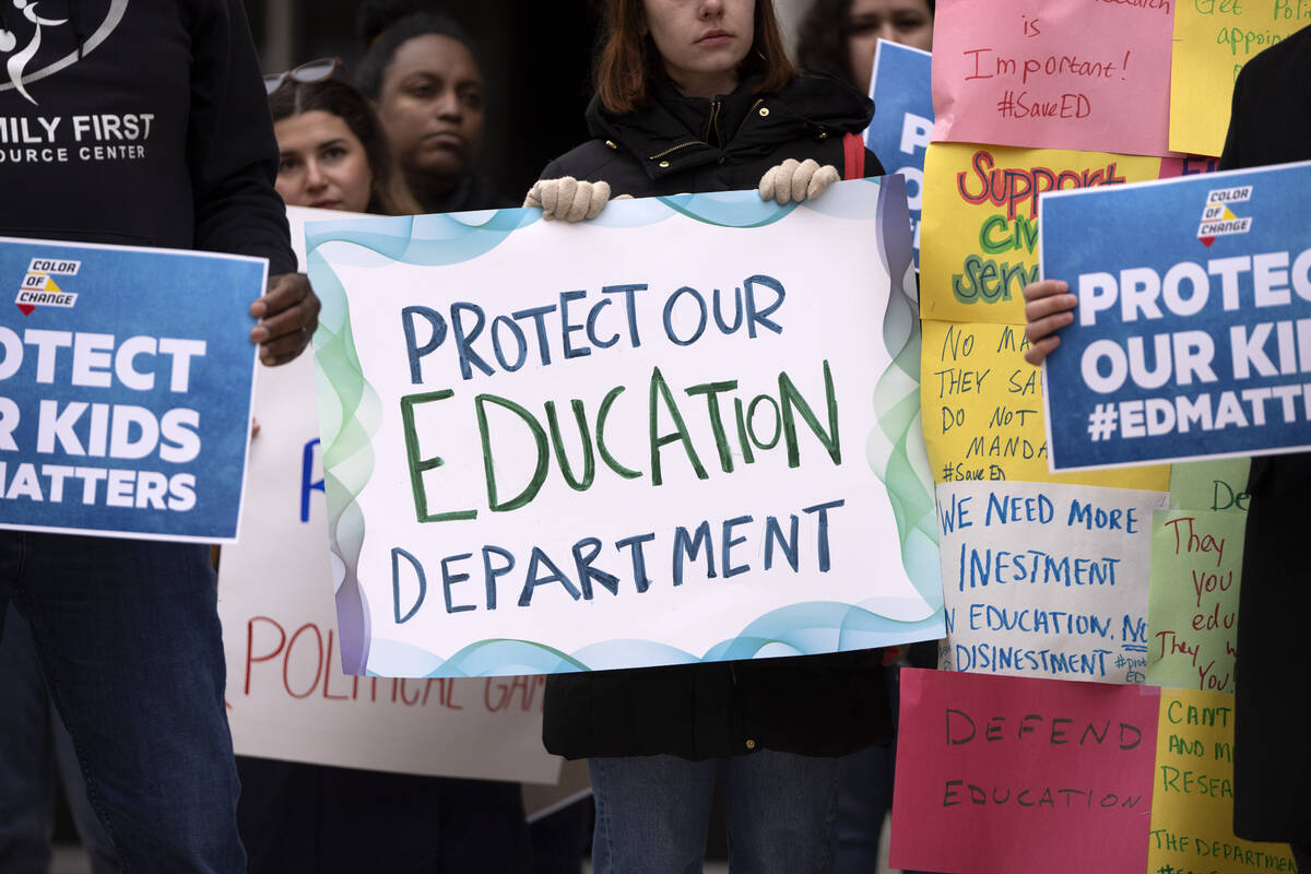 Protestors gather during a demonstration at the headquarters of the Department of Education, Fr ...
