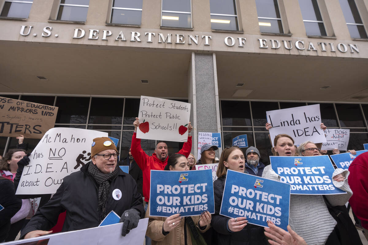Protestors gather during a demonstration at the headquarters of the Department of Education, Fr ...