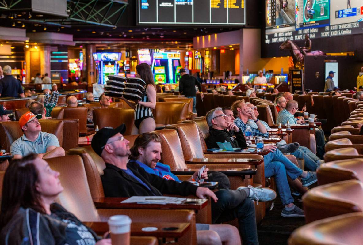 Bettors relax in the comfy loungers as they take in the early action during first day of NCAA T ...