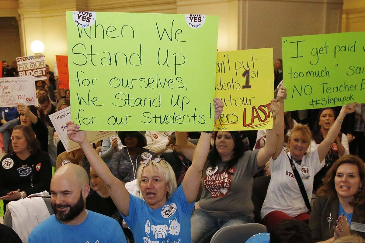 FILE - In this Feb. 12, 2018, file photo, Edmond school counselor Wendy Joseph, left, cheers wi ...