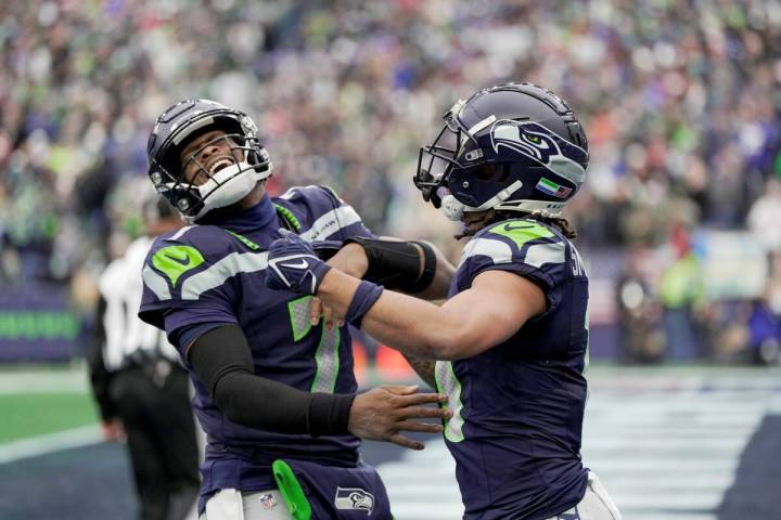 Seattle Seahawks quarterback Geno Smith (7) celebrates with Seattle Seahawks wide receiver Jaxo ...