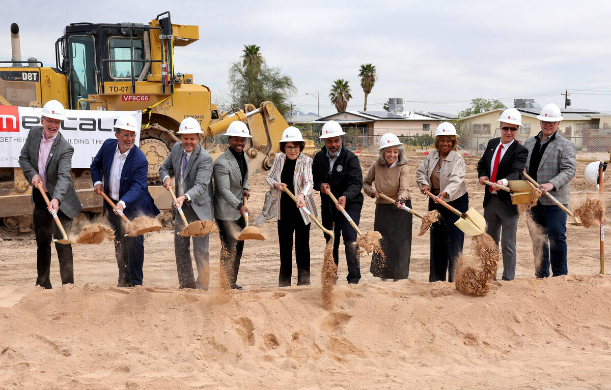 Dignitaries break ground during a ceremony on a mixed-use development combining, workforce hous ...