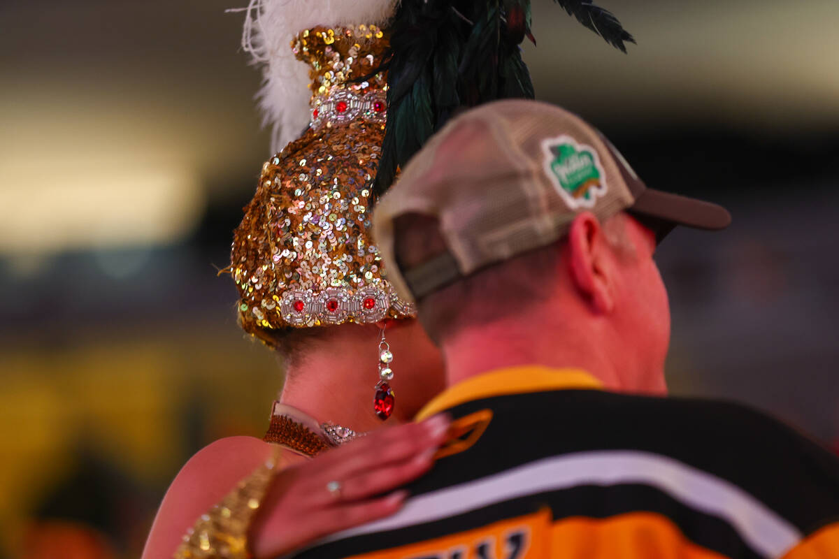 A Vegas Belle takes a photo with a fan before the game between the Golden Knights and the Bosto ...