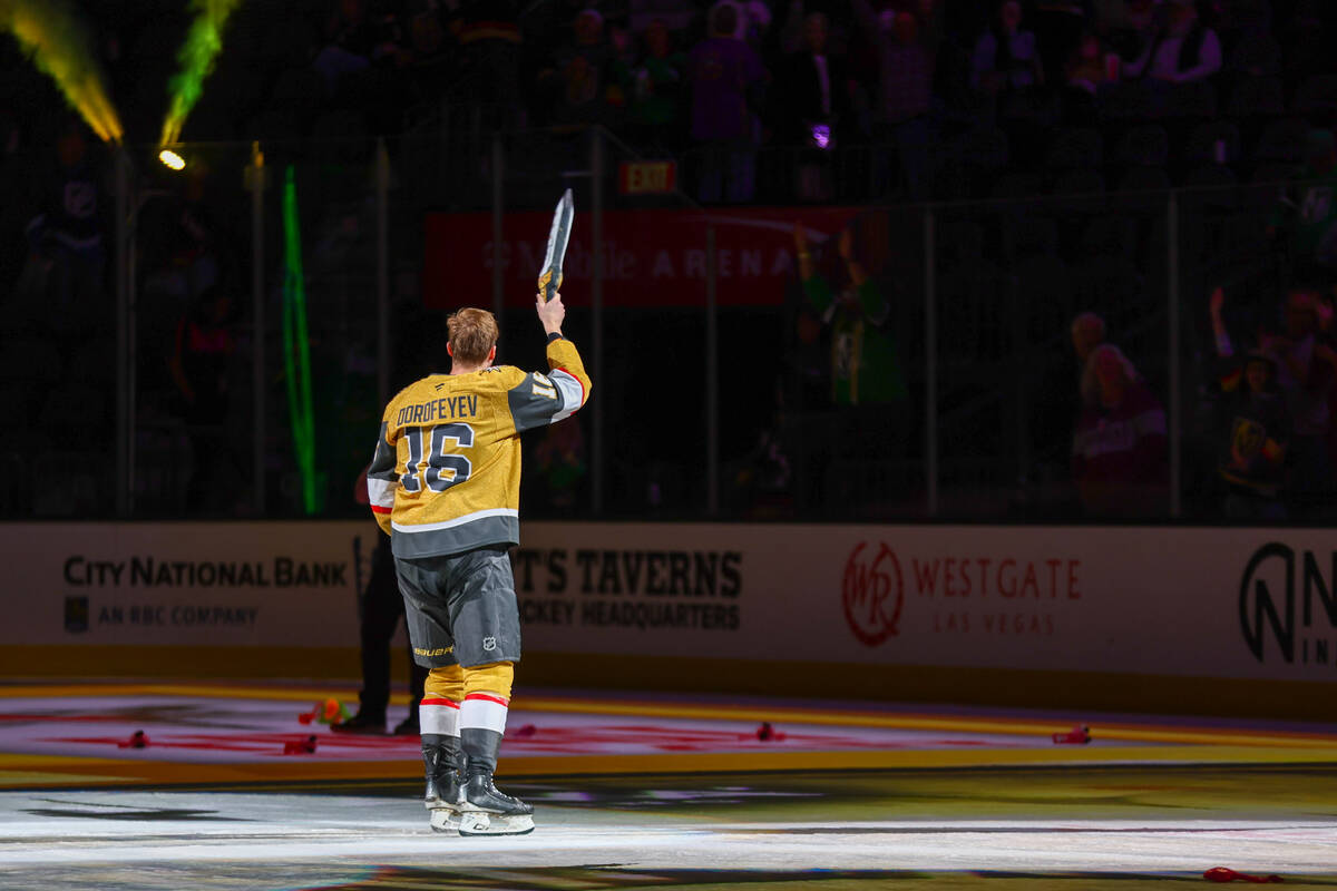 Golden Knights left wing Pavel Dorofeyev (16) is honored for his hat trick at the end of the ga ...