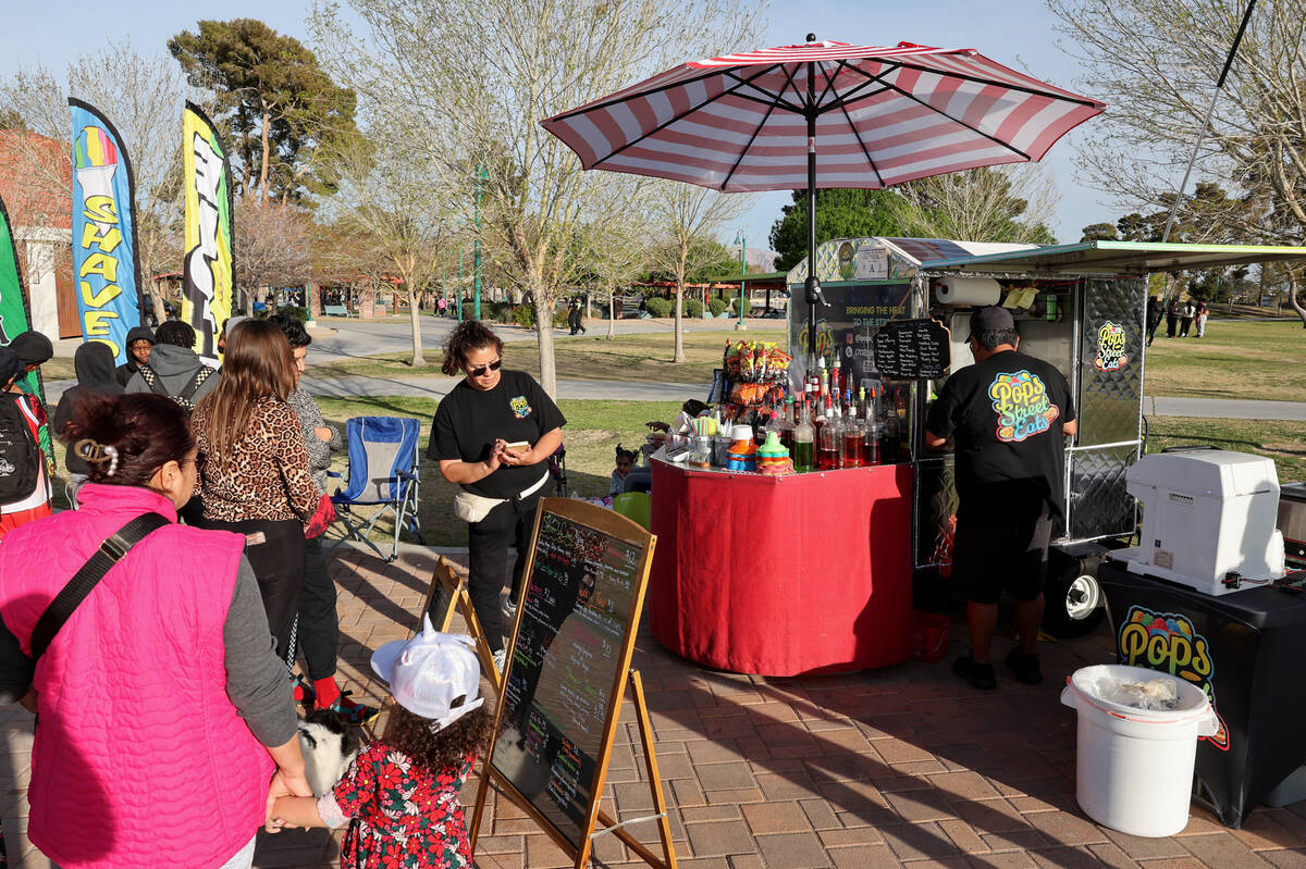 Jesus and Graciela Rodriguez serve customers from the Little Beans Cafe vending cart, previousl ...