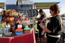 Jesus and Graciela Rodriguez serve customers from the Little Beans Cafe vending cart, previousl ...