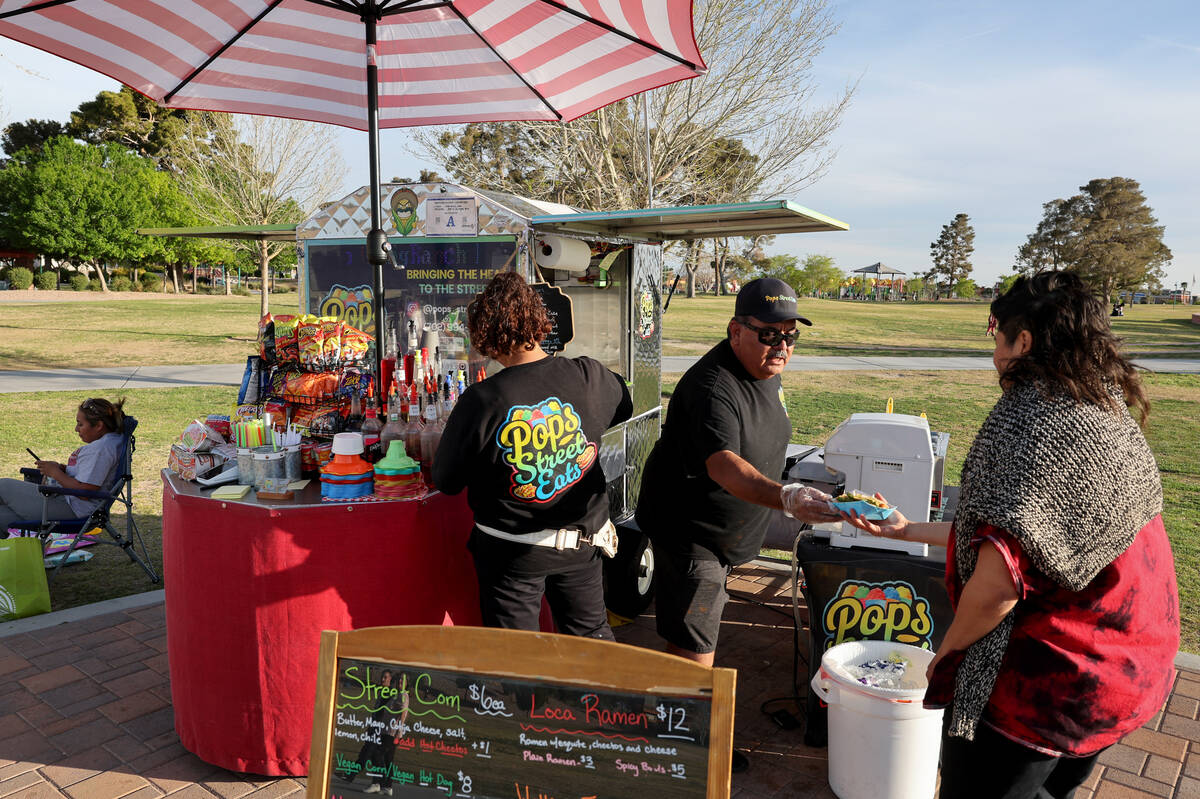 Jesus and Graciela Rodriguez serve customers from the Little Beans Cafe vending cart, previousl ...