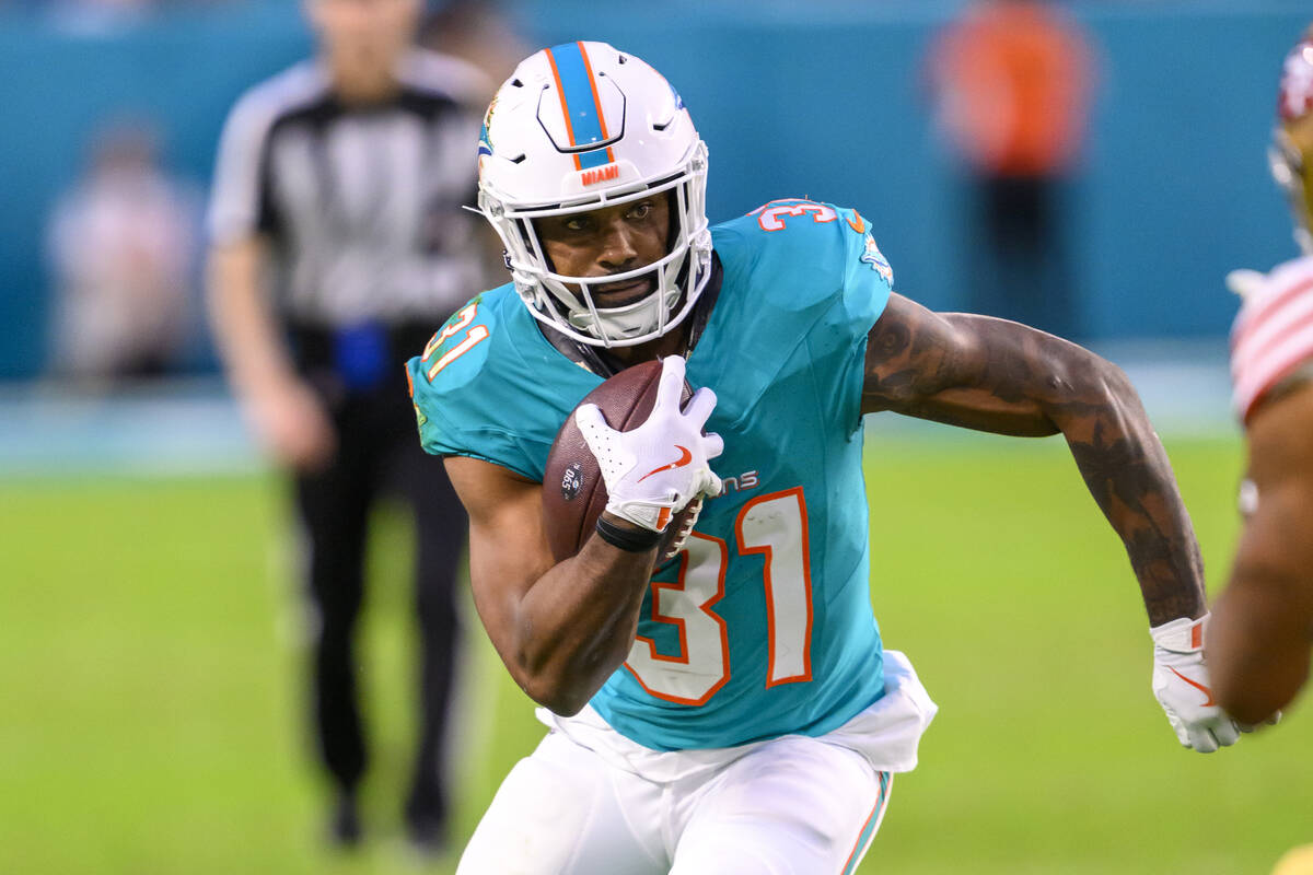 Miami Dolphins running back Raheem Mostert (31) carries the ball during an NFL football game ag ...