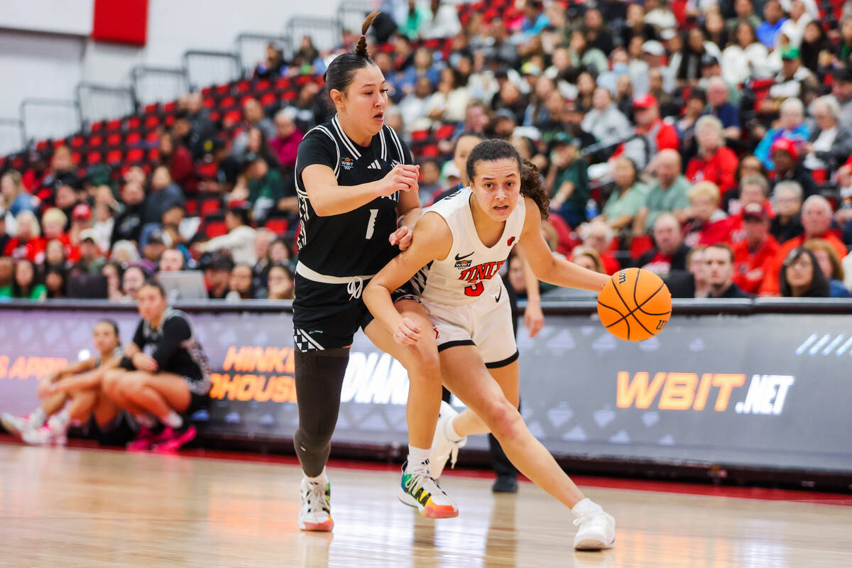 Lady Rebels guard Kiara Jackson (3) dribbles the ball as Hawai'i Rainbow Wahine guard Kelsie Im ...