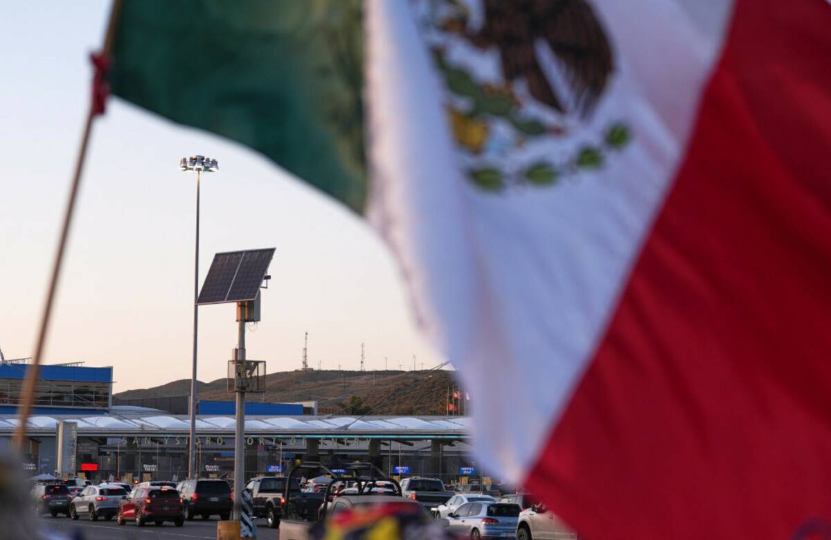 Vehicles wait in line to cross the border into the United States at the San Ysidro Port of Entr ...
