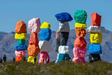 Visitors stop by to see the Seven Magic Mountains art installation on Wednesday, March 20, 2024 ...