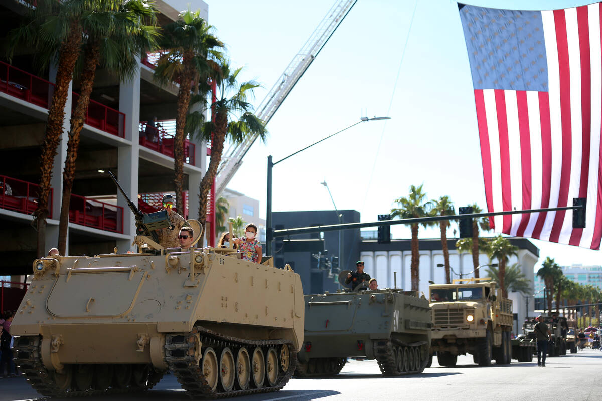 Participants make their way down the Veterans Day parade route on 4th Street in downtown Las Ve ...