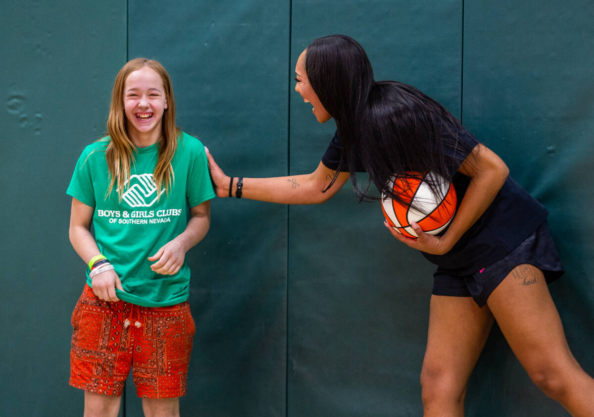 Aces star A'ja Wilson shares a fun moment with Alexa Steiner, 12, as she readies for a skills c ...