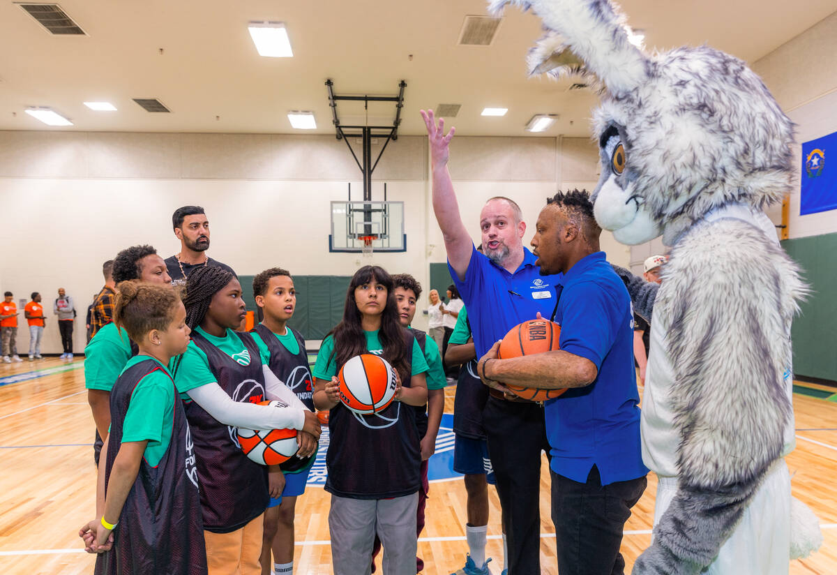 Kids get instructions for a skills challenge as the Aces A'ja Wilson and 2K Foundations help un ...