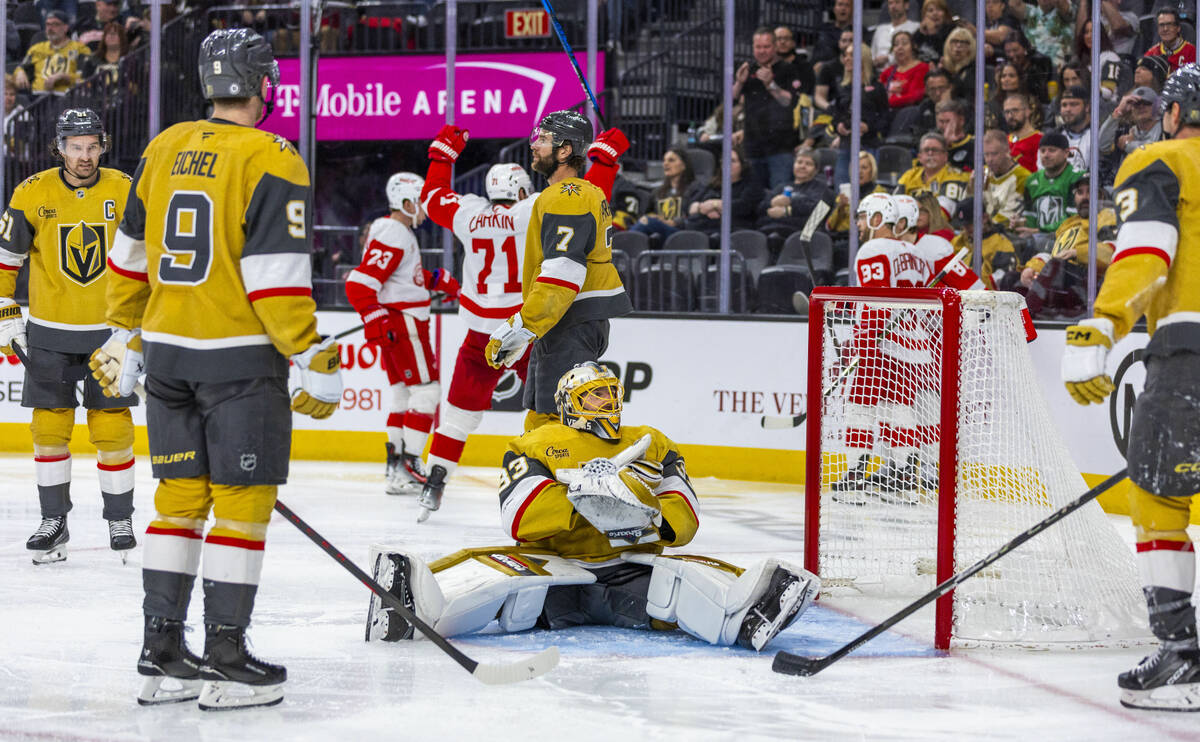 Golden Knights goaltender Adin Hill (33) is upset about a score by the Detroit Red Wings nearby ...