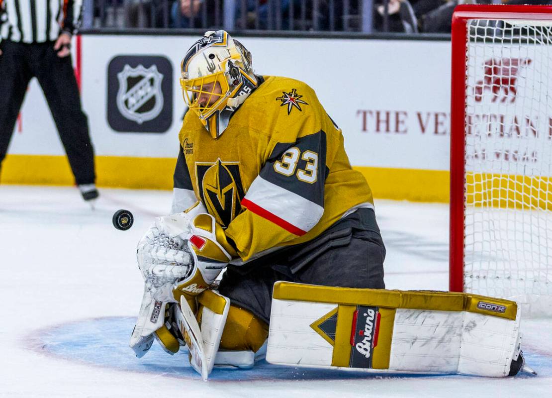 Golden Knights goaltender Adin Hill (33) knocks down a shot by the Detroit Red Wings nearby dur ...