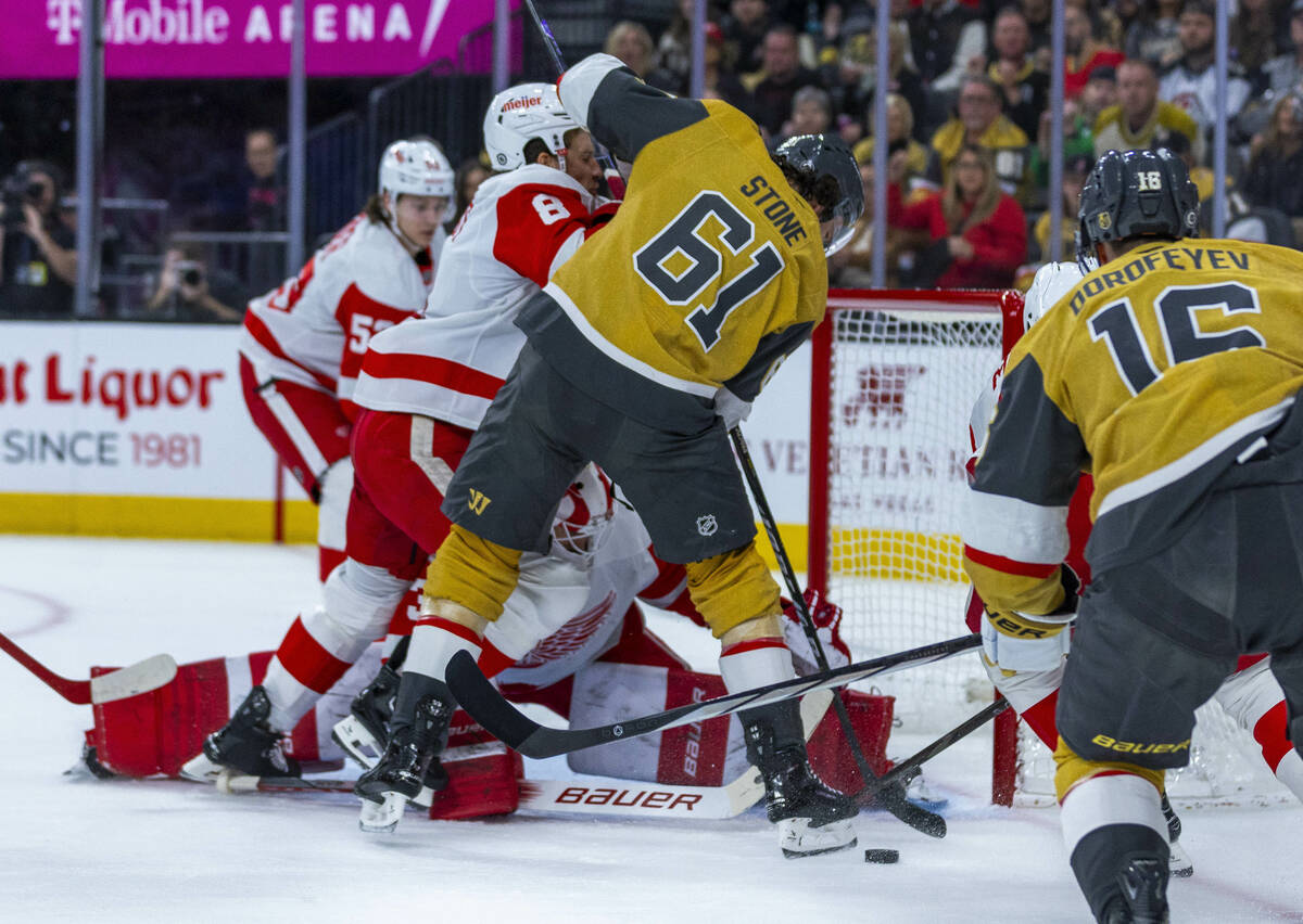 Golden Knights right wing Mark Stone (61) attempts to sneak the puck in against Detroit Red Win ...