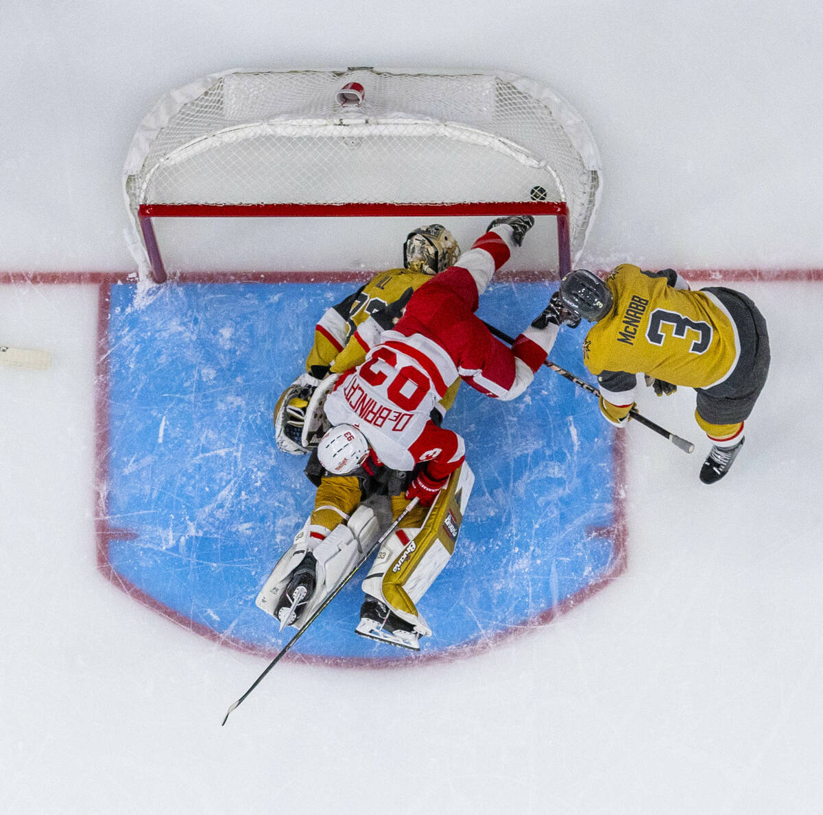 Golden Knights goaltender Adin Hill (33) looks to a puck which went between his legs as Detroit ...