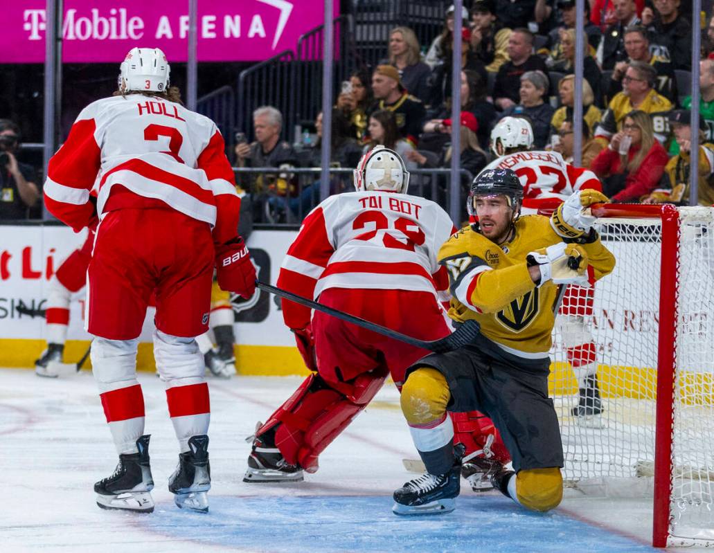 Golden Knights right wing Reilly Smith (19) picks himself up from the goal after crashing into ...