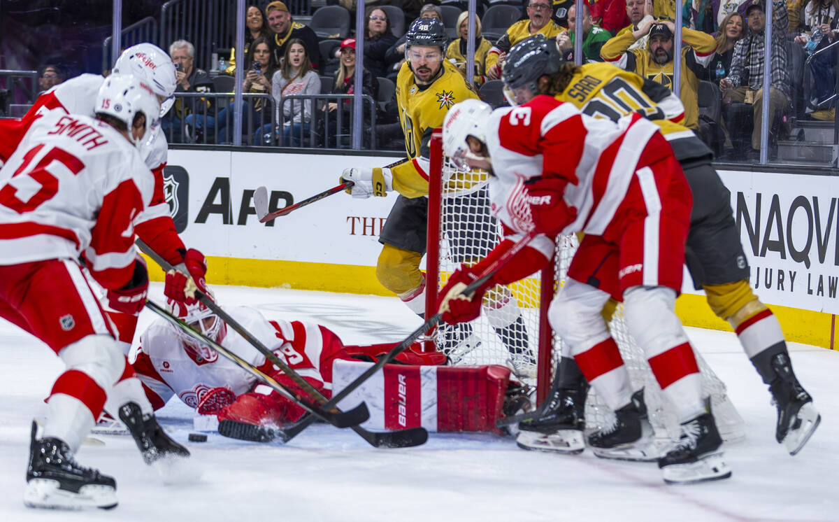 Detroit Red Wings goaltender Cam Talbot (39) reaches for a loose puck hit by Golden Knights lef ...