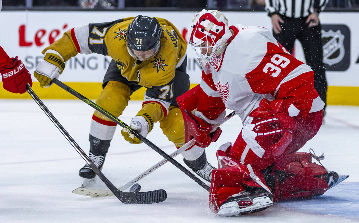 Golden Knights center William Karlsson (71) battles for the puck with Detroit Red Wings goalten ...