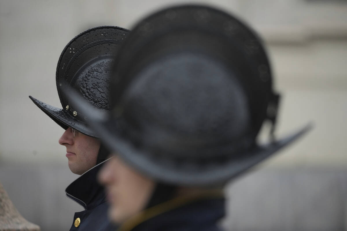 Pontifical Swiss Guards patrol during a mass for the jubilar pilgrims from Naples wait for the ...