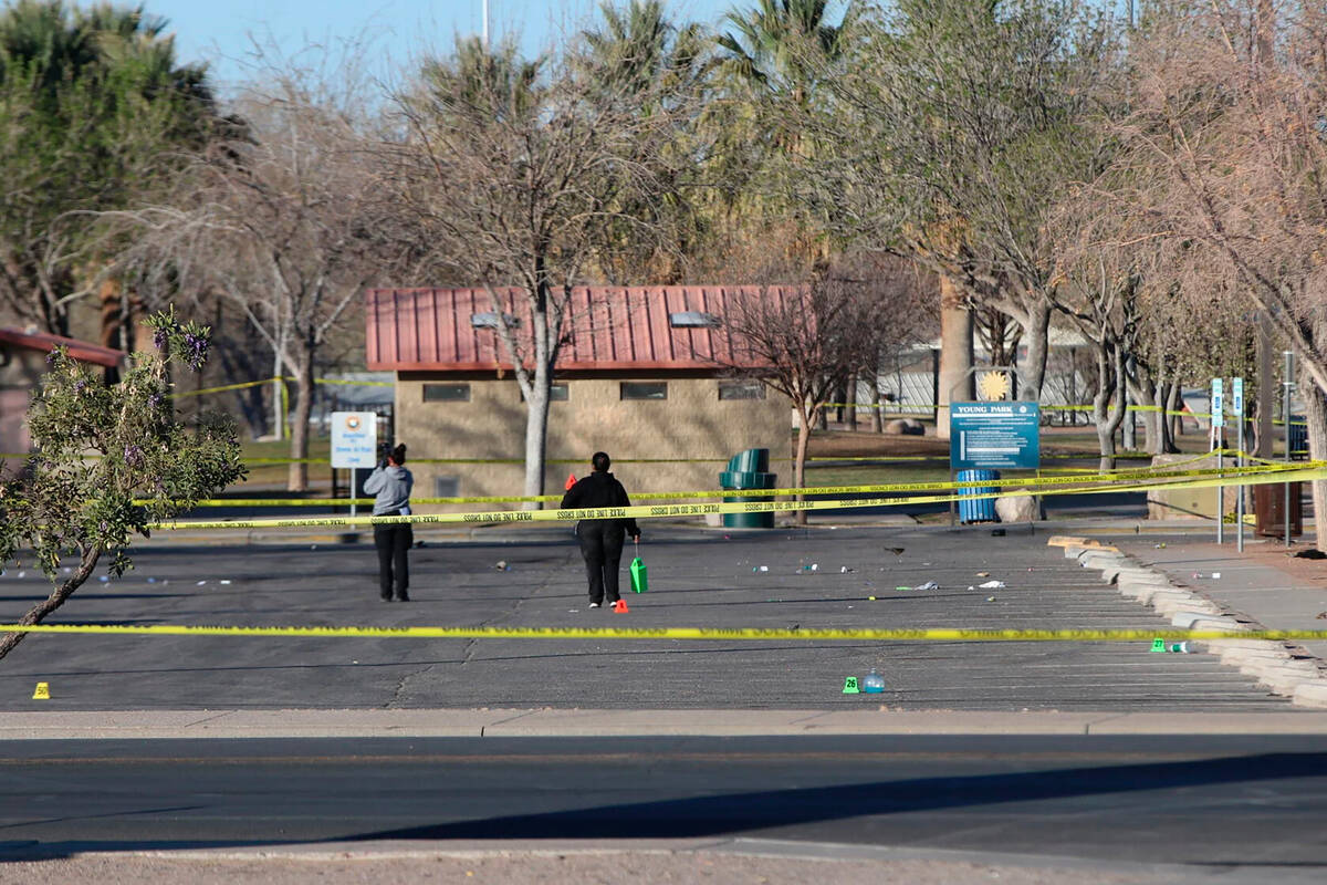 Crime scene technicians look over the Young Park parking lot after a mass shooting overnight, S ...
