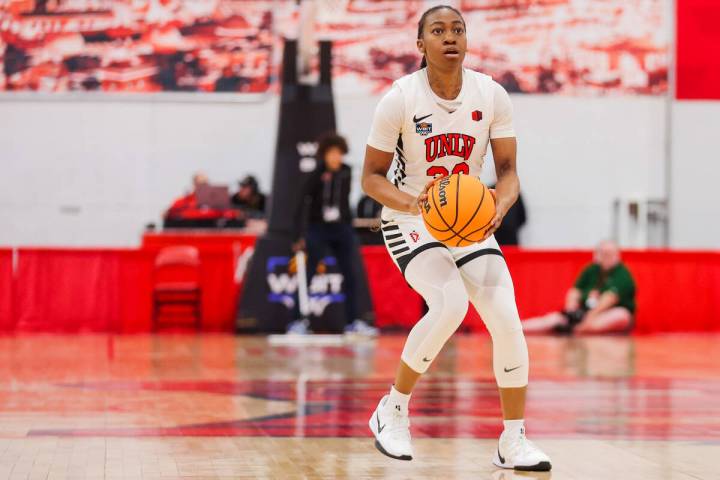 Lady Rebels guard Amarachi Kimpson (33) readies herself to shoot a three point shot during a Wo ...