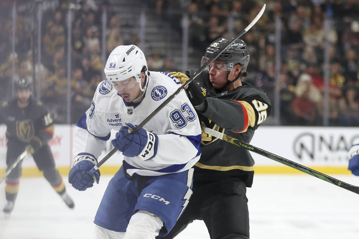 Vegas Golden Knights right wing Victor Olofsson (95) pushes Tampa Bay Lightning center Gage Gon ...