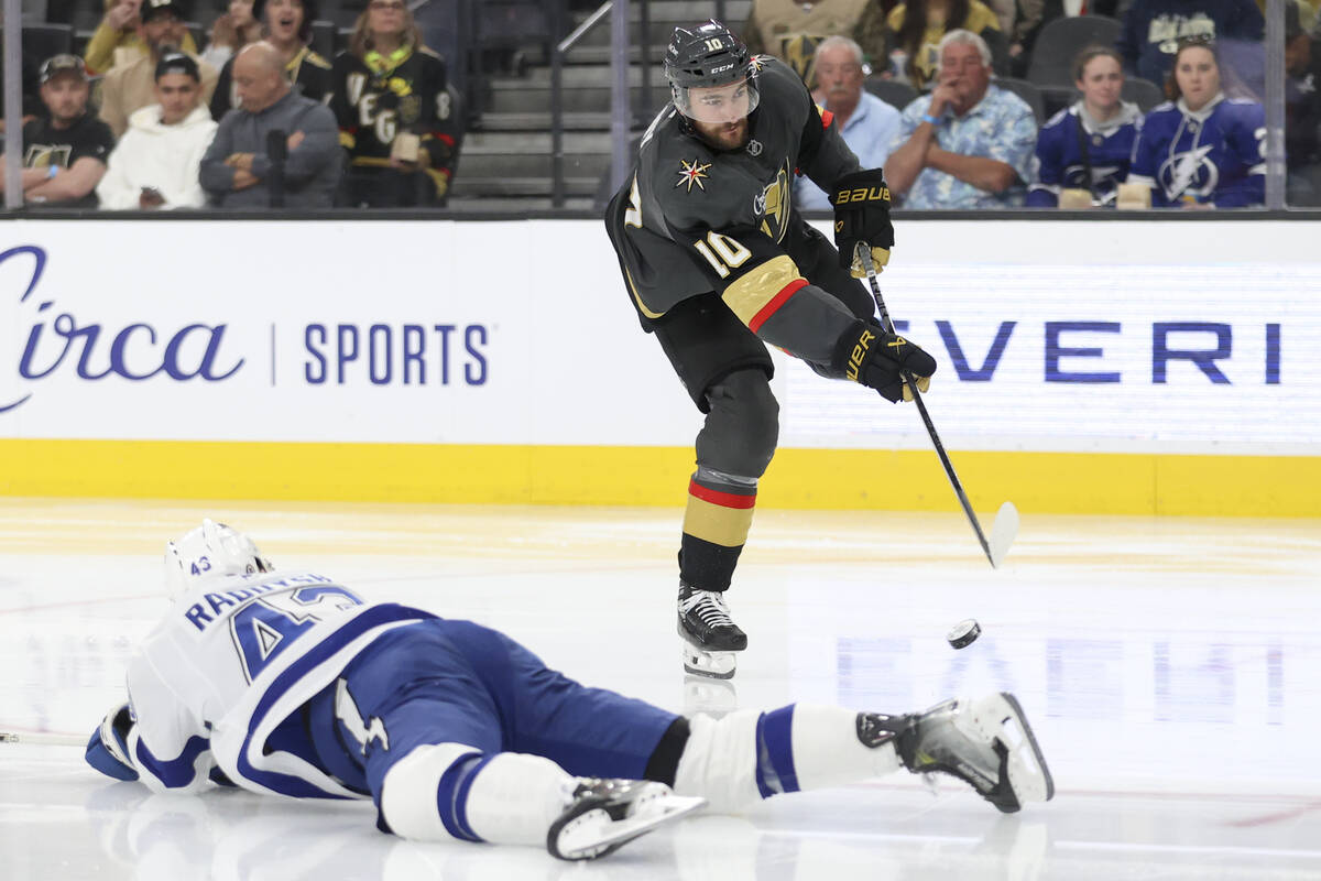 Vegas Golden Knights center Nicolas Roy (10) shoots while Tampa Bay Lightning defenseman Darren ...