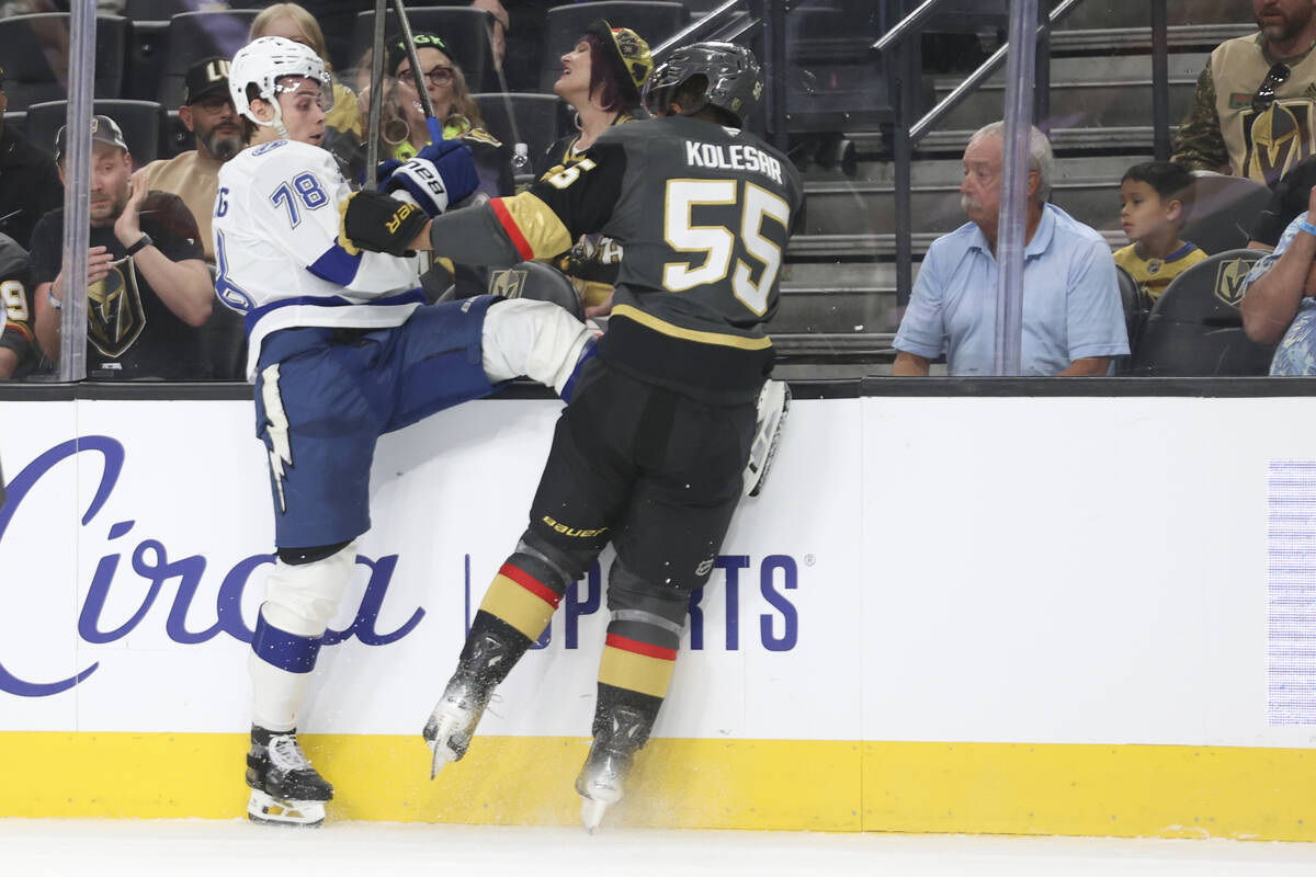 Vegas Golden Knights right wing Keegan Kolesar (55) checks Tampa Bay Lightning defenseman Emil ...