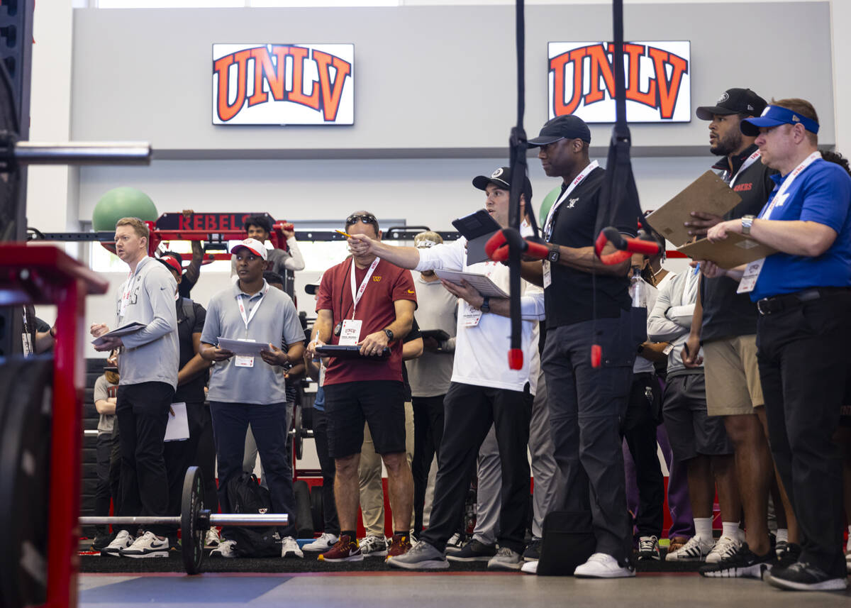 NFL scouts react during the bench press portion of UNLV football's Pro Day at the Fertitta Foot ...
